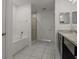 Bathroom with a separate tub and shower, along with modern fixtures and granite countertops at 622 Taft Dr, Davenport, FL 33837