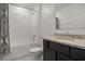 Bathroom with white subway tile in the shower and a dark vanity with granite countertops at 622 Taft Dr, Davenport, FL 33837