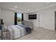 Cozy bedroom features modern design elements, a TV, and natural light through a window at 622 Taft Dr, Davenport, FL 33837