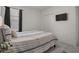 Bedroom showing the queen bed with tiled floors, white walls, closet, and mounted TV at 622 Taft Dr, Davenport, FL 33837