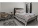 Bedroom featuring a queen bed, light gray walls, tile floors, and a side table with decorations at 622 Taft Dr, Davenport, FL 33837