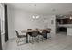Open dining room with a modern chandelier, a table with six chairs, and tile flooring at 622 Taft Dr, Davenport, FL 33837
