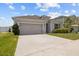 Charming single-story home with a well-manicured lawn, tidy landscaping, and a two-car garage at 622 Taft Dr, Davenport, FL 33837