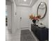 Welcoming foyer with neutral colors, decorative mirror, console, and ceramic tile flooring at 622 Taft Dr, Davenport, FL 33837