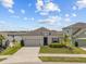 Charming single-story home with a well-manicured lawn, tidy landscaping, and a two-car garage at 622 Taft Dr, Davenport, FL 33837