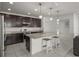 Modern kitchen with dark wood cabinets, granite countertops, a center island, and stainless steel appliances at 622 Taft Dr, Davenport, FL 33837