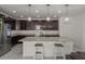 A modern kitchen with stainless steel appliances, granite countertops, and dark wood cabinetry at 622 Taft Dr, Davenport, FL 33837