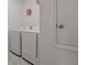 Laundry area with white appliances and decorative wall hangings and tile floors at 622 Taft Dr, Davenport, FL 33837