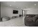 Spacious living room with a large TV, modern furnishings, and recessed lighting at 622 Taft Dr, Davenport, FL 33837