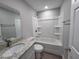 Bathroom featuring a granite vanity, sink, toilet, and tub with shower at 628 Se Pine Ave, Fort Meade, FL 33841