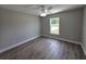 Bedroom with ceiling fan, wood-look flooring, and a window at 628 Se Pine Ave, Fort Meade, FL 33841