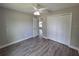 Bedroom with wood floors, ceiling fan, double closet and a view to the hall at 628 Se Pine Ave, Fort Meade, FL 33841