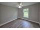 Bedroom featuring a ceiling fan, and wood floors with neutral paint at 628 Se Pine Ave, Fort Meade, FL 33841
