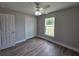 Bright bedroom featuring a ceiling fan, wood floors, and a window view at 628 Se Pine Ave, Fort Meade, FL 33841