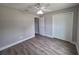 Bedroom with ceiling fan, wood-look flooring, and closet at 628 Se Pine Ave, Fort Meade, FL 33841