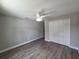 Bedroom with ceiling fan, wood-look flooring, and closet at 628 Se Pine Ave, Fort Meade, FL 33841