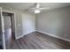 Bedroom with wood floors, ceiling fan, double closet and a view to the hall at 628 Se Pine Ave, Fort Meade, FL 33841