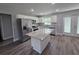 Spacious kitchen featuring a center island, stainless steel appliances, white cabinets, and granite countertops at 628 Se Pine Ave, Fort Meade, FL 33841