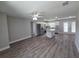 Open-concept kitchen featuring stainless steel appliances, white cabinetry, and an island with granite countertops at 628 Se Pine Ave, Fort Meade, FL 33841