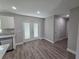Bright kitchen with stainless steel appliances, granite countertops, white cabinets, and backyard access at 628 Se Pine Ave, Fort Meade, FL 33841