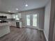 Bright kitchen with stainless steel appliances, granite countertops, white cabinets, and backyard access at 628 Se Pine Ave, Fort Meade, FL 33841