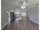 Open kitchen featuring stainless steel appliances, granite countertops, a center island, and wood-look floors at 628 Se Pine Ave, Fort Meade, FL 33841