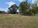 Sprawling lot with mature trees, a serene and private setting, and a red home on the adjacent property at 628 Se Pine Ave, Fort Meade, FL 33841