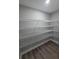Walk-in pantry with wire shelving and wood-look flooring at 628 Se Pine Ave, Fort Meade, FL 33841