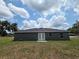 Exterior back view of the home with a well maintained lawn and blue skies at 628 Se Pine Ave, Fort Meade, FL 33841