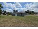 Back view of the home with a manicured lawn and neighborhood views at 628 Se Pine Ave, Fort Meade, FL 33841
