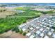 Aerial of home in a neighborhood close to highway and mature wooded area near lake at 6470 Peppertree Ne Path, Winter Haven, FL 33881