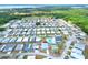 This aerial shows home located within a well-maintained manufactured home community with lake views at 6470 Peppertree Ne Path, Winter Haven, FL 33881