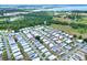 Aerial view showing home in the community and its proximity to lake and mature green space at 6470 Peppertree Ne Path, Winter Haven, FL 33881