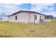 This image showcases the side of the house with a well-maintained lawn and air conditioning unit at 6470 Peppertree Ne Path, Winter Haven, FL 33881