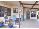 Welcoming front entrance featuring a covered patio, outdoor seating, and well-maintained landscaping at 6470 Peppertree Ne Path, Winter Haven, FL 33881