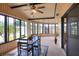 Inviting Florida room with ample windows, a ceiling fan, and a dining set for entertaining at 6470 Peppertree Ne Path, Winter Haven, FL 33881