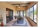 Bright Florida room featuring a ceiling fan, ample windows, and a cozy dining space at 6470 Peppertree Ne Path, Winter Haven, FL 33881