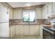 Bright kitchen with white cabinets, a dual sink, and modern appliances at 6470 Peppertree Ne Path, Winter Haven, FL 33881