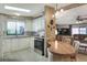 Charming kitchen features a breakfast bar, ample cabinetry, and skylight at 6470 Peppertree Ne Path, Winter Haven, FL 33881