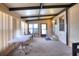 Enclosed lanai featuring neutral carpet, large windows, white vinyl table and door to exterior of the property at 6470 Peppertree Ne Path, Winter Haven, FL 33881