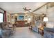 Cozy living room featuring comfortable seating, a ceiling fan, and lots of natural light at 6470 Peppertree Ne Path, Winter Haven, FL 33881