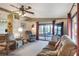 Spacious living room with a ceiling fan, comfortable seating, and a view of the screened lanai at 6470 Peppertree Ne Path, Winter Haven, FL 33881