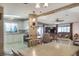 Open living space integrates a kitchen, dining area and Gathering room at 6470 Peppertree Ne Path, Winter Haven, FL 33881