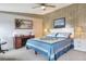 Comfortable main bedroom features a ceiling fan and a workspace at 6470 Peppertree Ne Path, Winter Haven, FL 33881