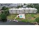Stunning aerial view of a waterfront condo building with a pool and private boat docks at 700 Mirror Nw Ter # 303, Winter Haven, FL 33881