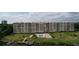 Aerial view of the building, pool, dock and boat slips, and lush landscaping at 700 Mirror Nw Ter # 303, Winter Haven, FL 33881