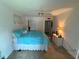 This is a bedroom with a ceiling fan, closet, and a comfy bed at 700 Mirror Nw Ter # 303, Winter Haven, FL 33881
