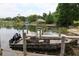 Boat dock with beautiful boat and lake view, perfect for enjoying the outdoors at 700 Mirror Nw Ter # 303, Winter Haven, FL 33881