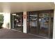 Building entrance features glass doors, signage, and manicured landscaping at 700 Mirror Nw Ter # 303, Winter Haven, FL 33881