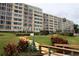 Lush green landscaping on steps up to building. Great location and view at 700 Mirror Nw Ter # 303, Winter Haven, FL 33881